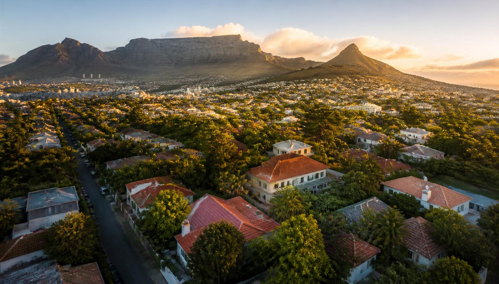 Aerial view of Cape Town suburbs with Table Mountain at golden hour